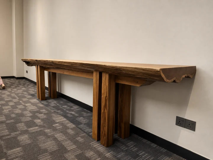 A substantial live-edge hardwood console with its natural grain and irregular edge