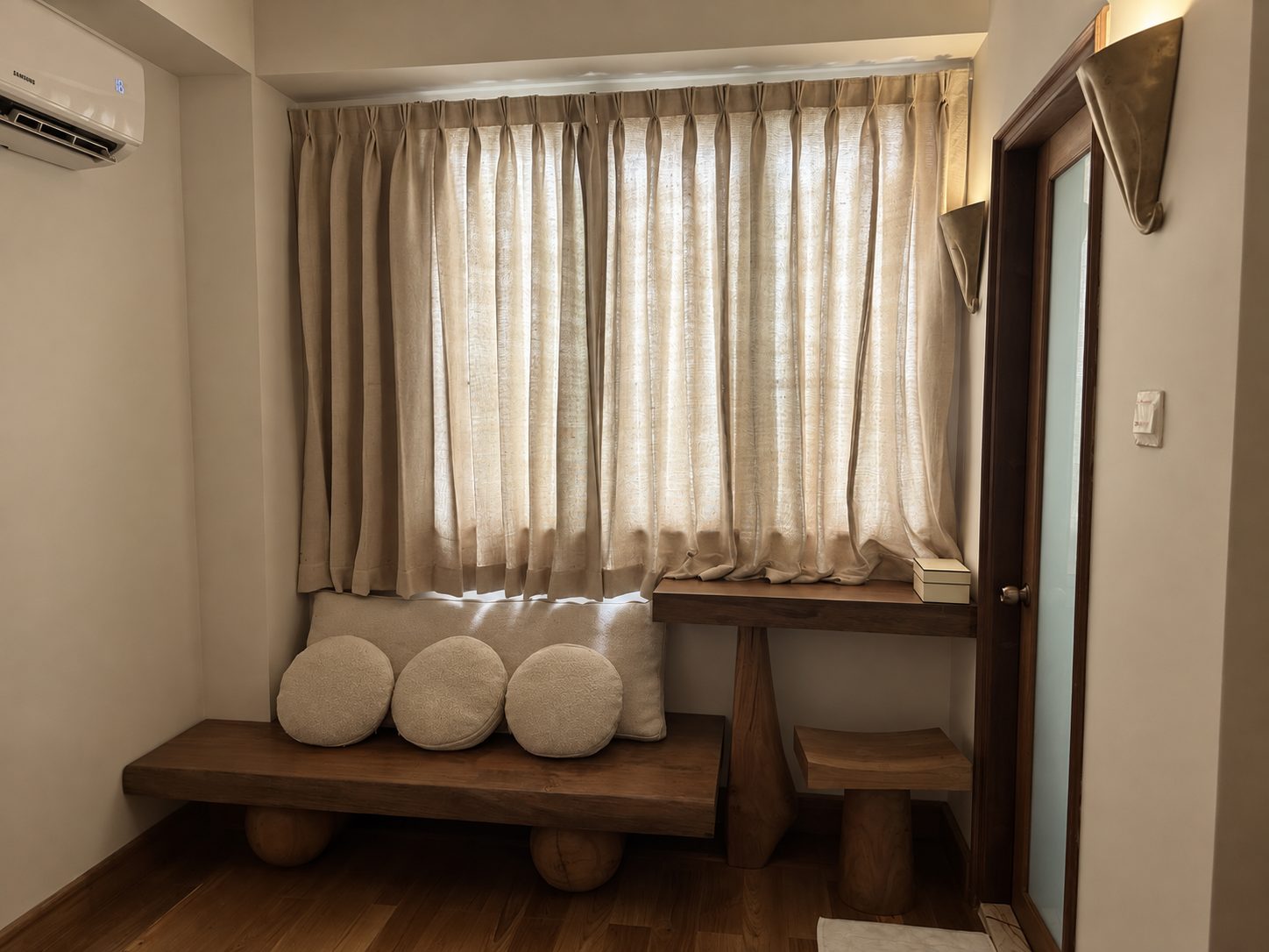 Window seat with teak bench and linen cushions